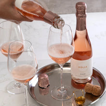 Pouring BOLLE Sparkling Rosé Demi 375ml non-alcoholic wine into glass on serving tray, award-winning alcohol-free champagne alternative