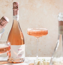 BOLLE Sparkling Rosé non-alcoholic wine in coupe glass with cheese pairing, award-winning alcohol-free champagne alternative