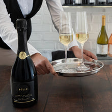 Pouring BOLLE Grand Reserve lees-aged non-alcoholic sparkling wine into champagne flutes, premium alcohol-free wine with bubbles