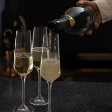 BOLLE Grand Reserve non-alcoholic sparkling wine champagne flutes being raised for celebration toast, premium alcohol-free champagne